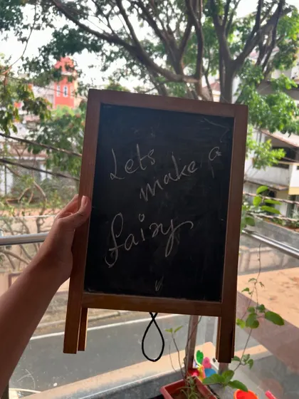 "Lets make a fairy". A simple prompt on our chalkboard is all it takes to get the magic started.