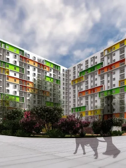 A perspective of the U-shaped building in the 'Play of Colors' development, designed to enclose a large, landscaped courtyard for community interaction.