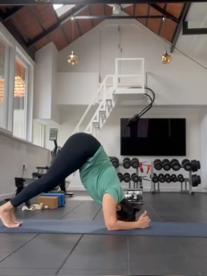 The same student transitions into Dolphin Pose, a great shoulder opener and preparation for inversions. Our classes focus on building a strong foundation through proper alignment and mindful transitions.