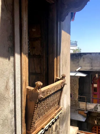 Another example of a traditional Rajasthani jharokha, or enclosed balcony, with intricate latticework. These architectural elements inspire our designs for creating private, shaded outdoor spaces.