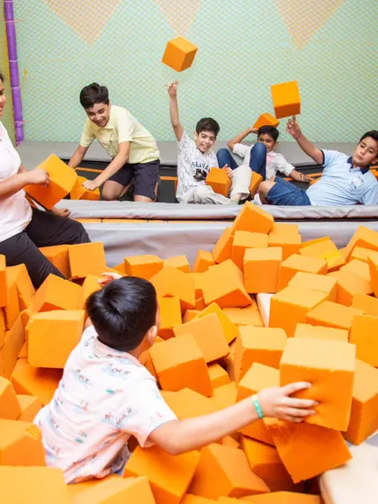 Friends are what make celebrations the best! A group of boys having a blast in the foam pit.