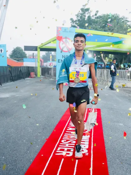 An athlete crossing the finish line with confetti falling. This is the moment all the hard training culminates in. A fantastic finish.