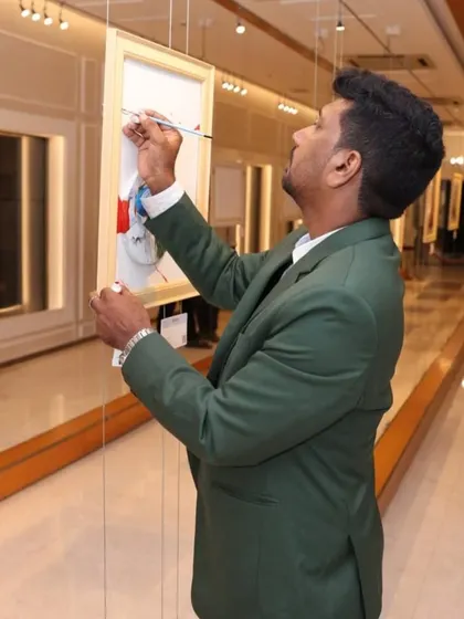 The artist Niladri Ghosh adding a final touch to one of his paintings during the 'Ethereal Charm' exhibition.