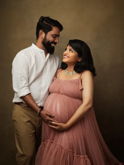 A beautiful fine art maternity portrait with a soft, romantic feel. The dusty rose gown and the couple's loving gaze make for a truly timeless image.