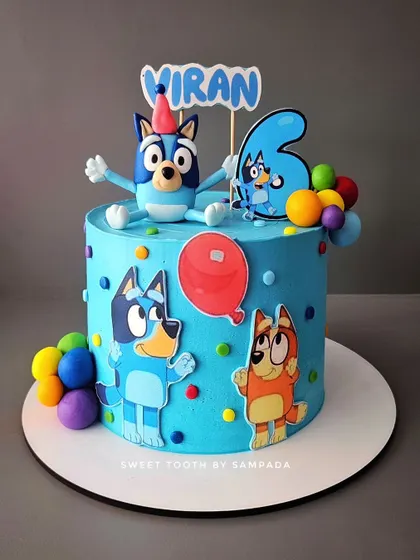 A fun Bluey cake for Viran's 6th birthday. This 2kg chocolate truffle and nutella cake is decorated with Bluey and his family, ready for a party with colorful balloons.