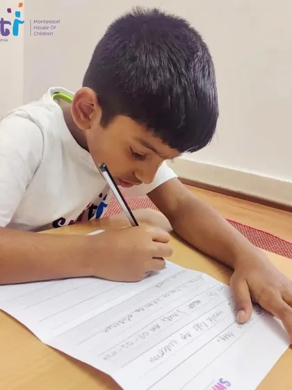 A student practices his cursive writing to prepare his letter for the post office trip. This gave his writing practice a real and exciting goal.
