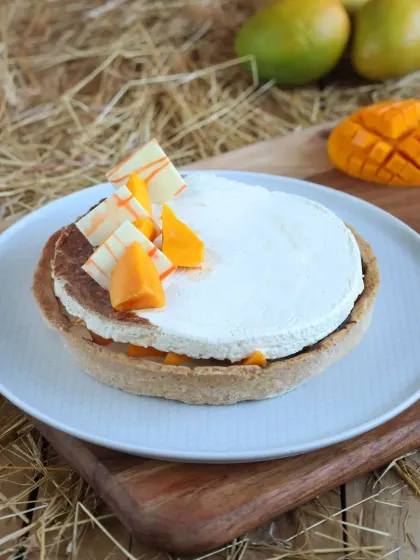This is our Mango Cheesecake Tart, combining the best of both worlds. It has a buttery tart shell filled with creamy cheesecake and topped with fresh mango.