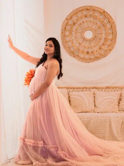 A soft and romantic portrait in our boho-chic setup. The light pink gown with its long train looks beautiful against the natural textures of the rattan furniture and light curtains.