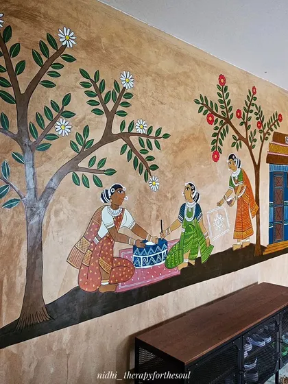An angled shot of the wall mural showing women engaged in morning rituals, demonstrating how the artwork creates depth and perspective along the length of the wall.