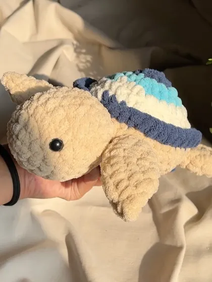A side view of the evil eye turtle, showing the layers of color that create the iconic design. It’s a modern twist on a classic good luck charm.