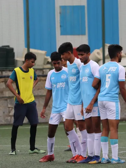 Players setting up a defensive wall. I teach the tactical side of the game, including how to organize and defend set pieces effectively.
