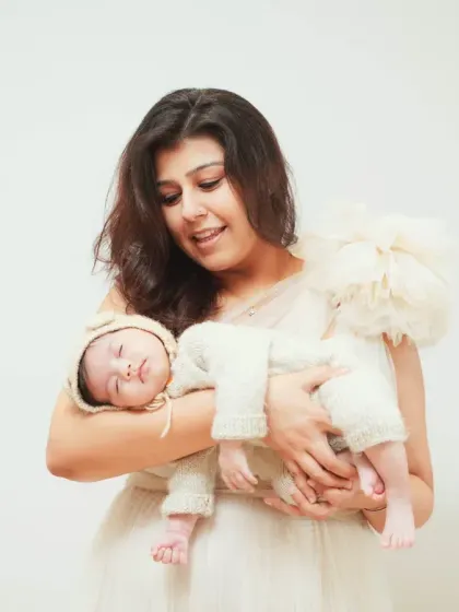 A mother's gentle embrace. This portrait highlights the peaceful and loving connection between a mom and her sleeping newborn.