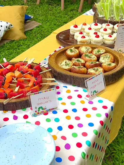 I believe party food should look as good as it tastes. This vibrant spread for a 'Very Hungry Caterpillar' themed party features colourful fruity skewers, mini veggie buns, and other aesthetic treats that are ready for their close-up.