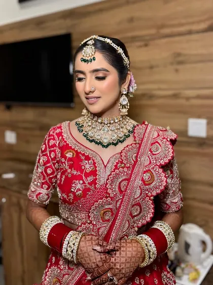 Simran looking serene and beautiful before her ceremony. The makeup was designed to be timeless, with a focus on flawless skin and soft contouring to enhance her features.