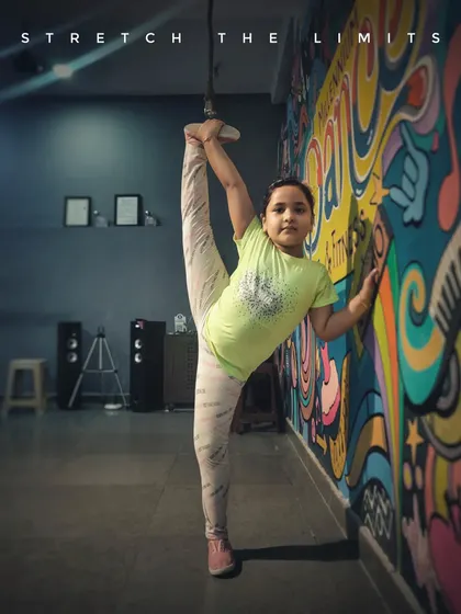 We help kids discover what their bodies are capable of. Here, one of my dedicated students shows incredible flexibility during a stretching session at our studio, proving that with practice, you can stretch your limits.