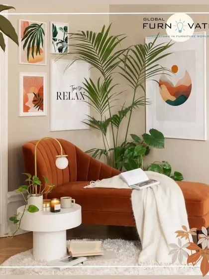 A cozy reading corner featuring a warm, rust-colored velvet chaise lounge. The space is decorated with botanical art prints and houseplants, creating a perfect spot to relax.