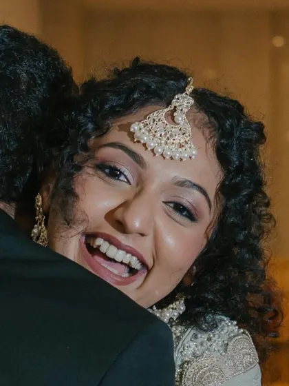 That hug says it all! A joyful, candid moment from the engagement party. Her makeup looks flawless and natural even in an unposed shot.