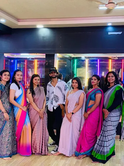 The instructor with his students during the saree-themed class.