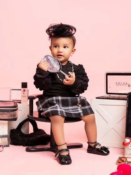 A duplicate of a previous shot, this image captures the little fashionista admiring her reflection, a perfect moment in her special birthday session.