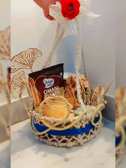 My bespoke luxury gift basket, featuring Omani dates, decorative pieces, and elegant golden accents in a handcrafted jute basket.