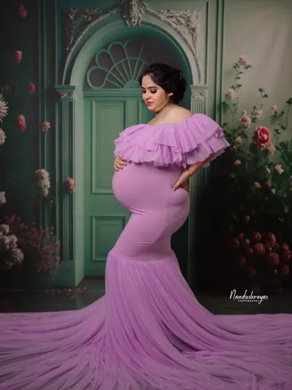 A solo portrait showcasing the elegant silhouette of the mother-to-be in a form-fitting lavender gown with a dramatic train.