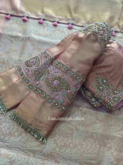 A close-up of the paisley embroidery on the dusty pink sleeves.