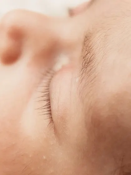 Another beautiful close-up of a newborn's long eyelashes.