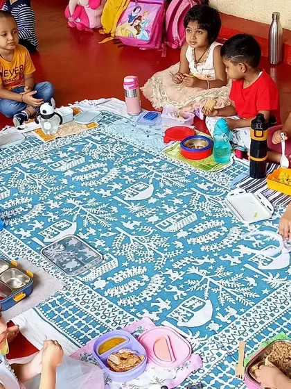 A community meal during our Children's Day celebration. Sharing food together on a large mat fosters a sense of family and togetherness among the children.