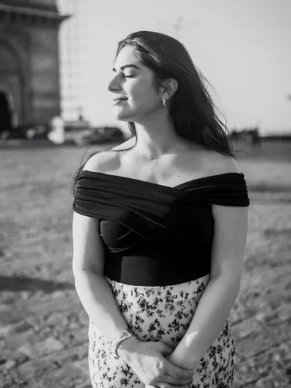 A serene black and white shot, capturing a quiet moment of reflection. The gentle breeze and closed eyes create a sense of peace and calm.
