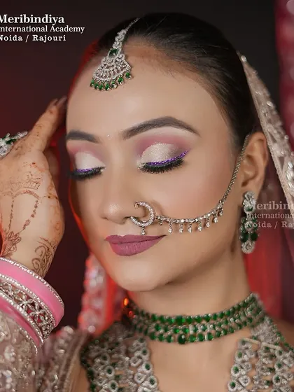 This look features soft, shimmery eye makeup with a pop of purple glitter, paired with a matte mauve lip. It's a perfect example of a modern reception look.