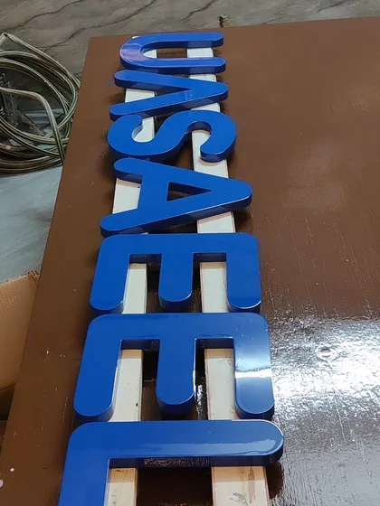 The complete set of letters, finished and ready for installation, showcasing a perfect high-gloss Duco finish.
