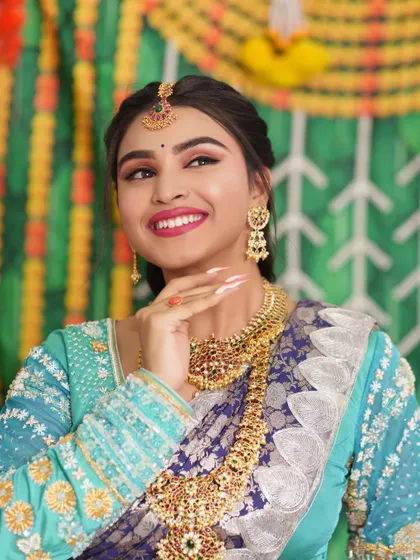 The bride's joyful expression perfectly complements the festive feel of her attire and jewellery.