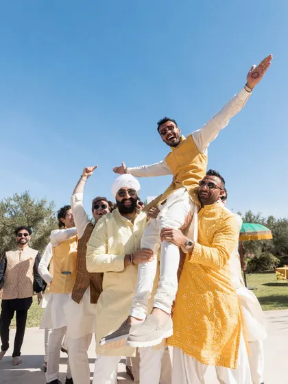 The groom and his groomsmen celebrating at the Haldi. These events are all about bringing friends and family together for moments of pure joy and energy.