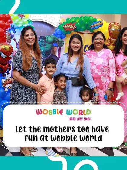 We believe moms should have fun too! Here, a group of mothers and their children pose for a happy picture during a party.