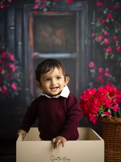 A sweet, curious expression from the toddler in the box, looking off to the side.