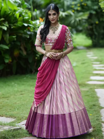 This shot showcases the elegant draping of the dupatta and the rich border of the Kanchipuram silk lehenga.