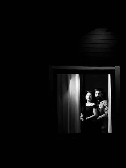 I love playing with light and shadow to create artistic and moody portraits. This monochrome pre-wedding photo uses a simple window frame to create a sense of intimacy and drama, proving that beautiful moments can be found anywhere.