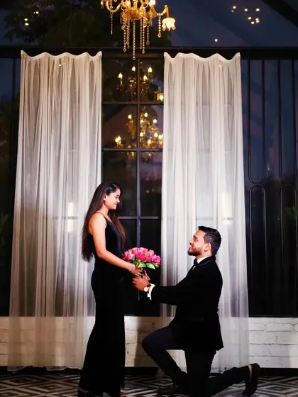 For a chic and sophisticated look, nothing beats classic black. This couple chose our black velvet slit gown and a matching velvet tuxedo for their pre-wedding photoshoot, creating an aura of timeless glamour.