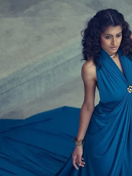A simple yet elegant look created by draping a single piece of blue fabric. The flowing train and classic silhouette prove that sometimes the simplest concepts are the most beautiful.