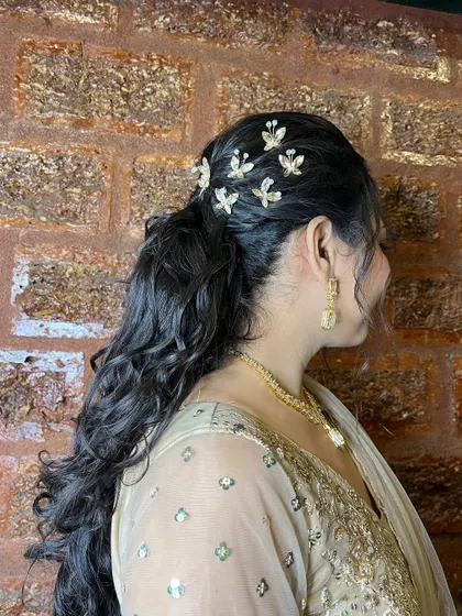 A detailed view of the modern ponytail hairstyle, adorned with delicate butterfly clips for a whimsical touch.