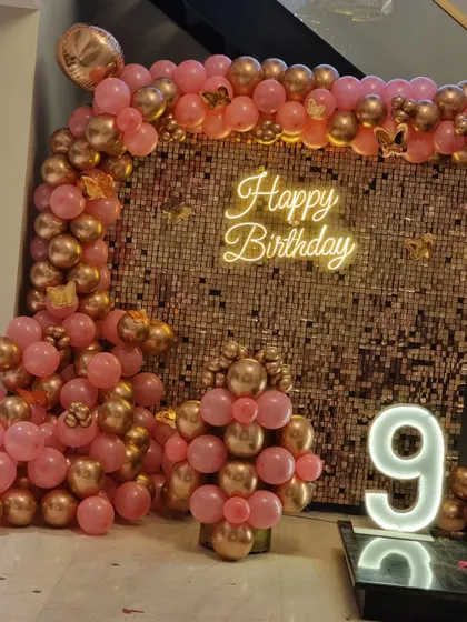 A close-up of the rose gold balloon arch and sequin wall.