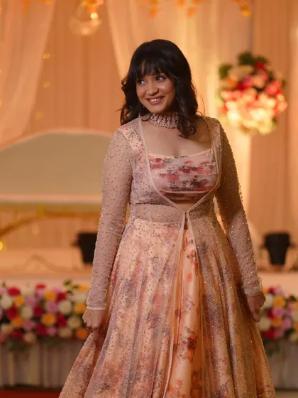 The bride-to-be looks radiant and happy. Her soft makeup and hairstyle are perfect for this pre-wedding celebration.