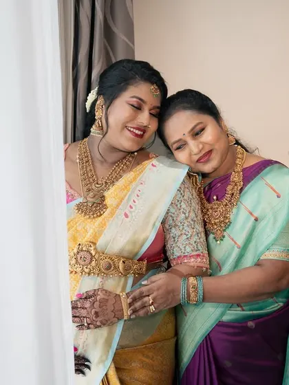 A heartwarming photo of the mother-to-be sharing a loving embrace with her own mother, a beautiful multi-generational moment.