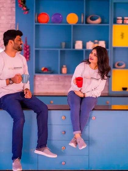 A fun, candid moment of a couple sharing a coffee in a colorful kitchen. This setup is great for capturing a slice of your everyday life together.