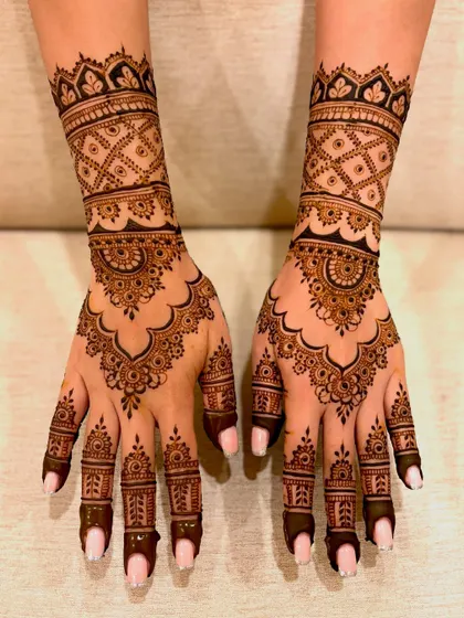 A top-down view of the complete engagement mehendi, showing the rich, dark application.
