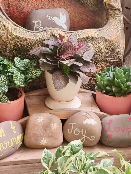 Sometimes it's the smallest things that bring the most joy. These hand-painted pebbles with words like 'Harmony', 'Joy', and 'Love' add a personal and positive touch to the garden.