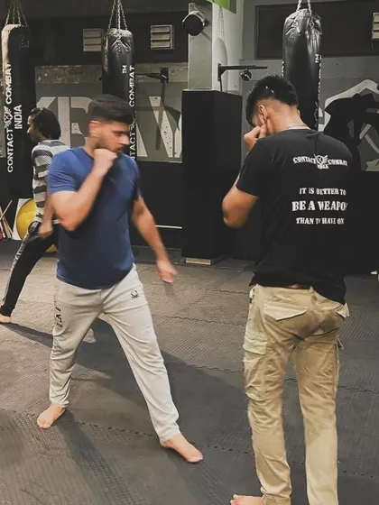 Two students spar, practicing their boxing and defensive movements. This kind of live drilling is essential for learning timing, distance, and how to read an opponent.