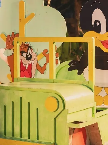 A fun prop of baby Daffy Duck and the Tasmanian Devil in a green jeep.