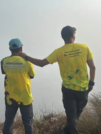 Two of our team members in official Miles To Trek apparel, looking out at the view. Our team is passionate about exploring and sharing the beauty of nature.