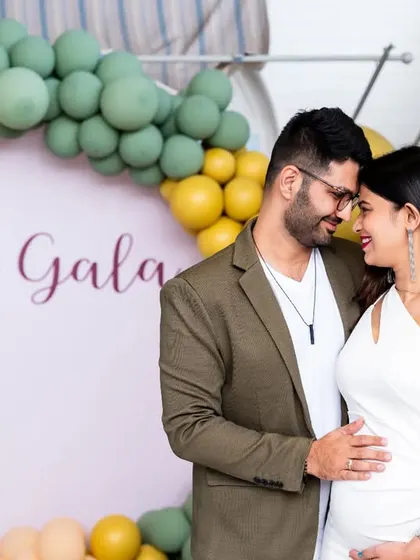 A quiet moment of connection for the parents-to-be at their baby shower. The soft, modern decor with the "Lil Gala" sign provides a beautiful backdrop for this intimate portrait.